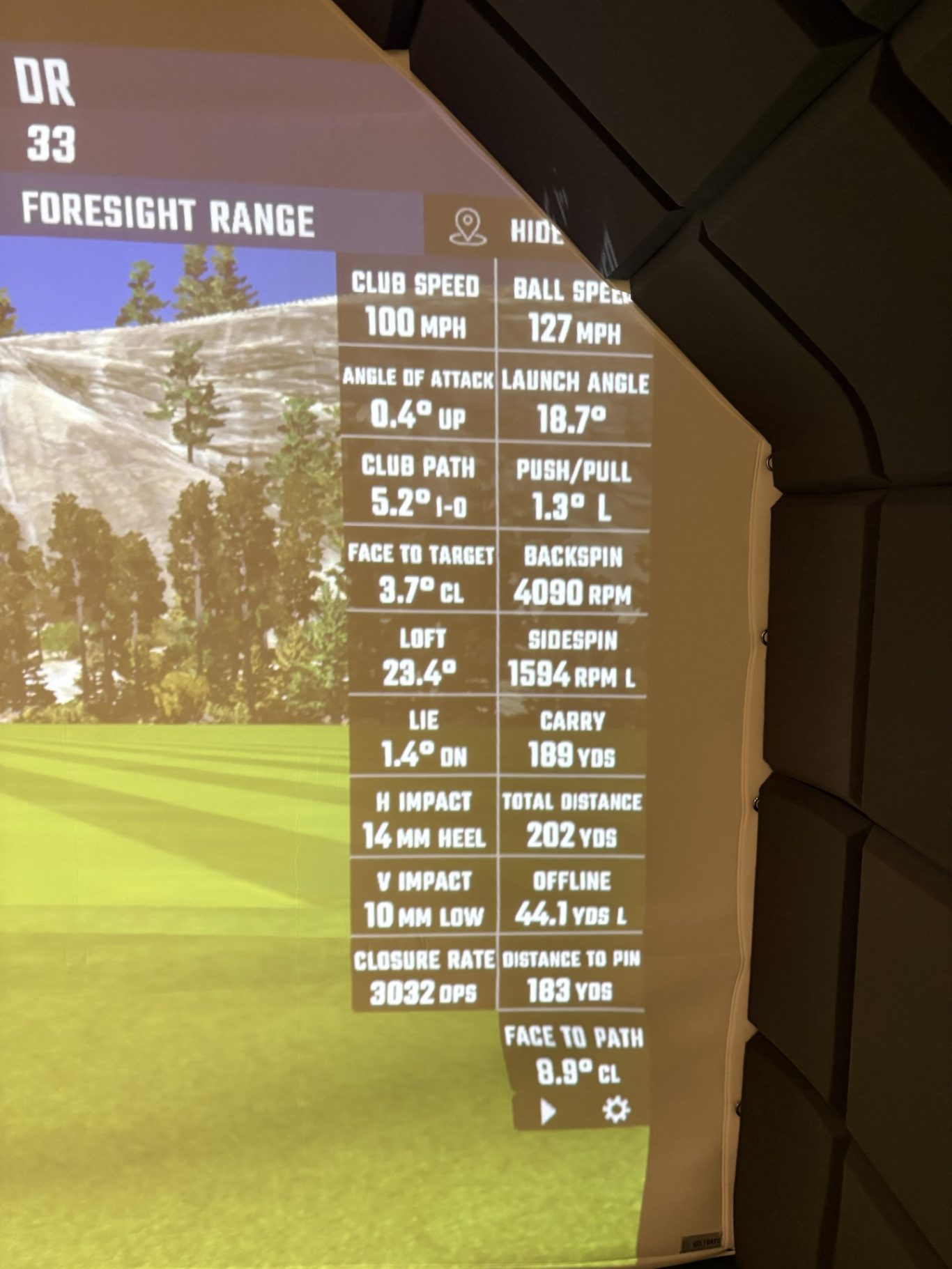 Golf simulator screen displaying shot data and statistics for a driving range session.